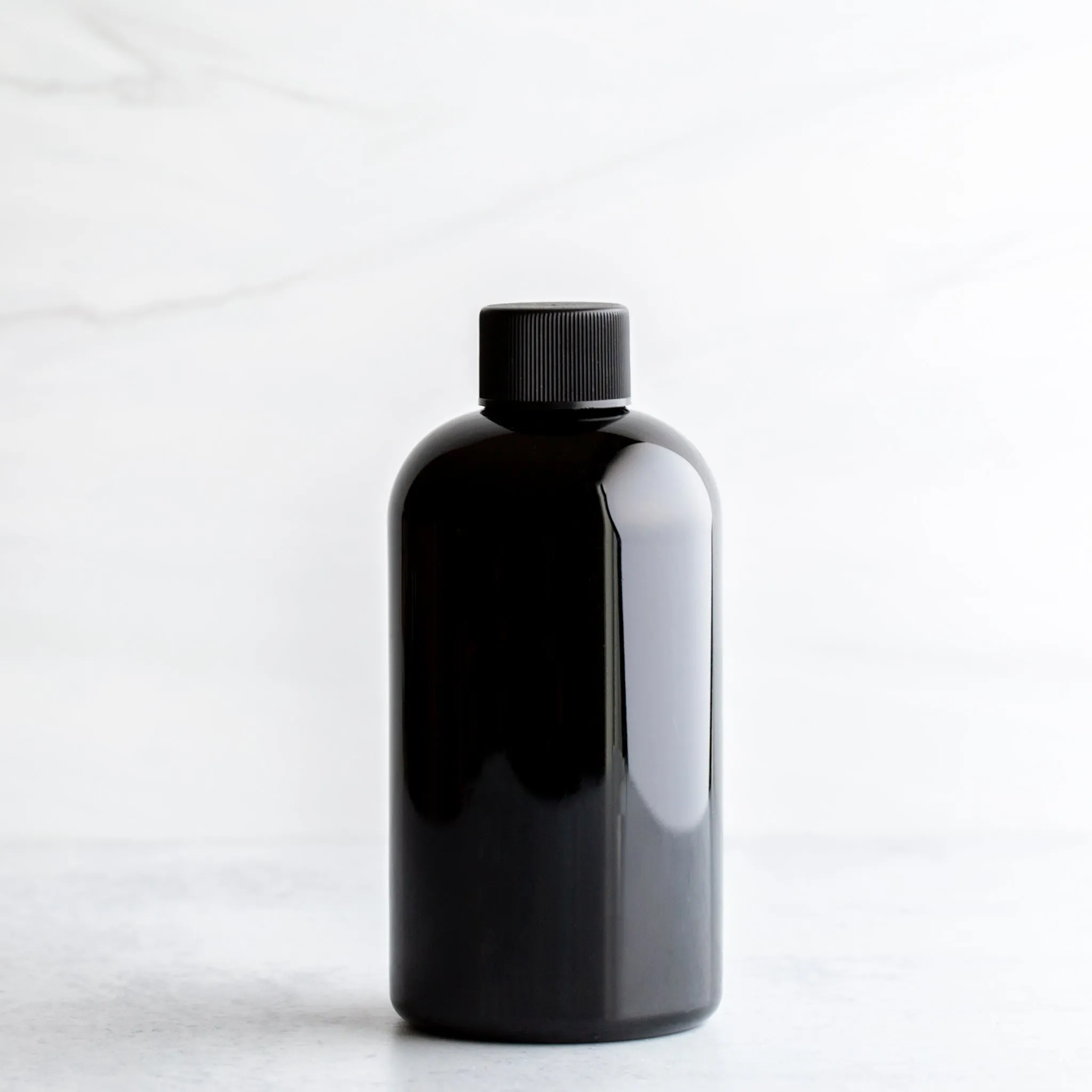 8 oz Black PET Boston Round Bottle With 24-410 Neck